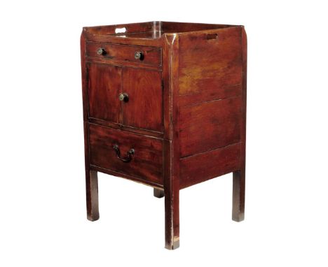 A George III mahogany tray-top commode, the gallery pierced with two handgrips above a frieze drawer and cupboard, the pull-o