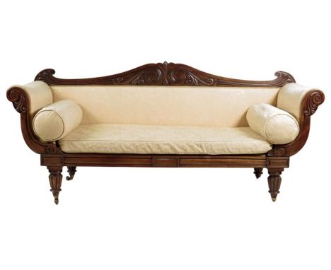 A George IV mahogany scroll end sofa, the shaped back carved with leaf scrolls above a squab and bolster cushions and on ribb