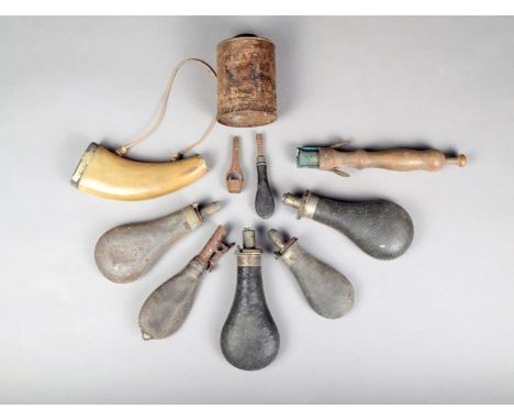 Three morocco leather powder flasks, a pig skin shot pouch, a nipple wrench, a wad cutter, another powder flask, a flattened 