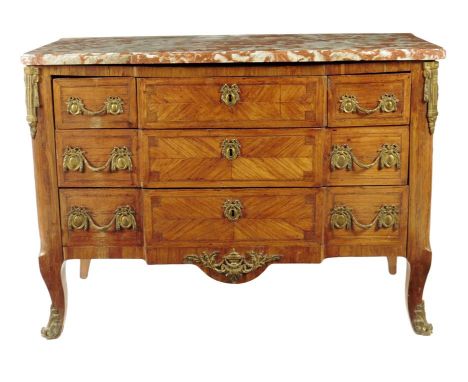 A Transitional kingwood commode, with ormolu mounts, the moulded incarnat turquin marble top above an arrangement of nine dra