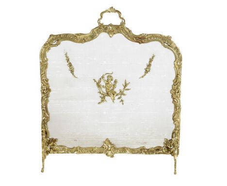 A French gilt brass fire-screen in Louis XV style, the cast frame decorated with rocaille, leaves and flowers with a central 