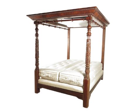A William IV mahogany four poster bed by Gillows of Lancaster, the flame veneered pelmet with egg and dart mouldings above tu