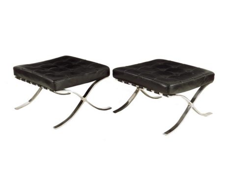 A pair of Barcelona chrome and black leather stools, originally designed by Ludwig Mies van der Rohe, each with a button upho