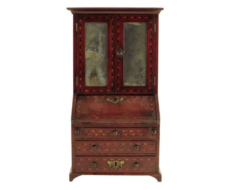 A George III mahogany miniature bureau bookcase, inlaid with chequer stringing and with a pair of glazed doors enclosing a sh