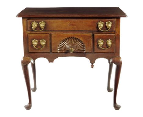 An 18th century American red walnut 'Chippendale' dressing table, the moulded edge top with re-entrant front corners, above a