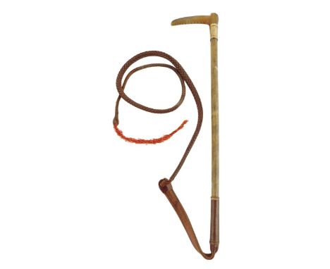 &lambda; A George V rhinoceros horn riding whip, the carved handle above a silver ferrule inscribed 'L.B. FROM C.F. 1929', th