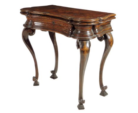 An early 18th century Italian walnut serpentine tea table, the hinged fold-over top banded in ash and inlaid with a coat of a