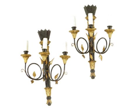 A pair of Italian ebonised and giltwood three light wall appliques in Empire style, modern, 61.2cm high, 37.8cm wide. (2)