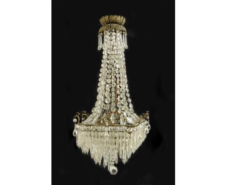 An Edwardian gilt brass and cut glass ceiling light, the leaf decorated corona above a frame hung with lustres and faceted dr