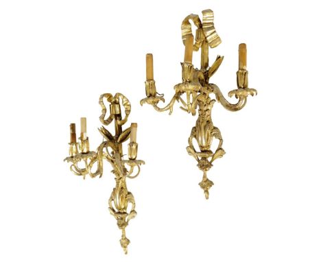 A pair of 19th century carved giltwood and gesso three light wall appliques, each with a ribbon tied back with leaf scroll ar