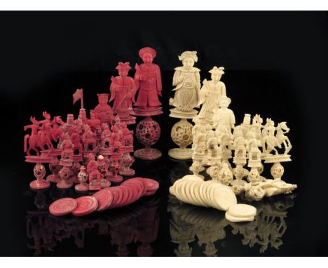 λ A late 19th century Chinese Canton carved ivory figural part chess set, with puzzle ball bases, natural and stained red, th