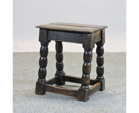 An 18th century oak joint stool. on bobbin turned legs, 40cm