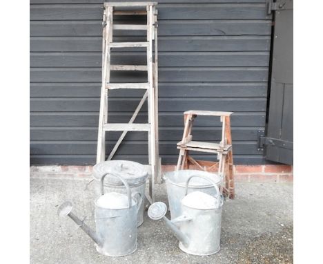 A wooden step ladder, together with another smaller, a galvanised watering can, another and two buckets
