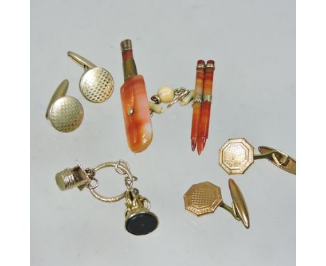 An early 20th century hardstone novelty fastener, in the form of a cricket bat and stumps, together with an unmarked bloodsto