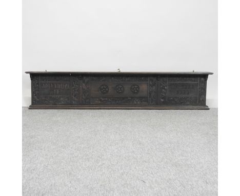 A 19th century oak wall shelf, carved with a latin inscription, 169cm