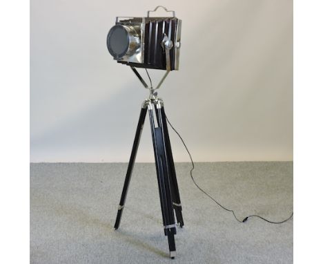 A chrome stage light, on an adjustable tripod base, 144cm high