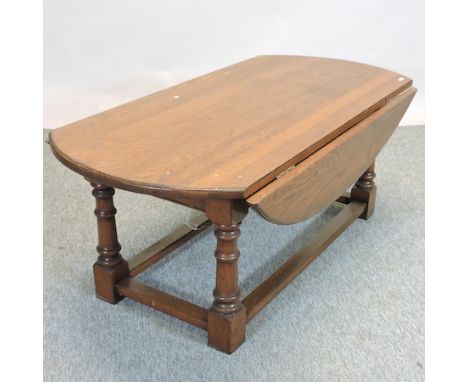 An oak drop leaf coffee table, together with an oak stick stand