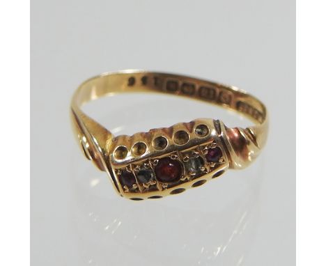 An antique 18 carat gold ruby and diamond ring, of asymmetrical design