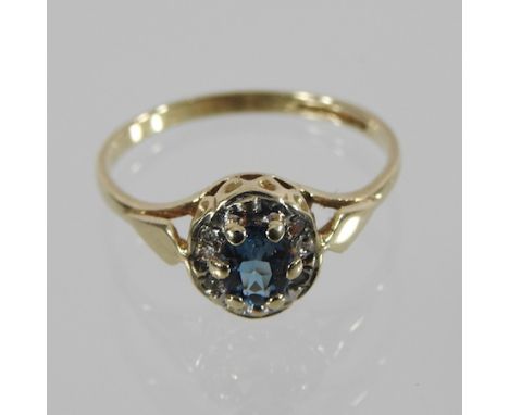 A 9 carat gold topaz and diamond cluster ring, boxed