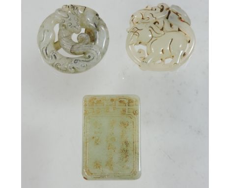 A collection of three 20th century carved jade coloured pendants, largest 6cm