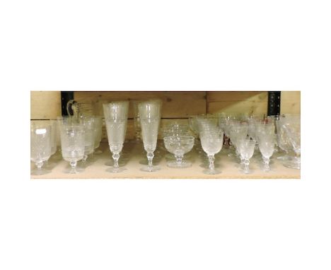 A shelf of cut glass and other drinking glasses, with hobnail decoration