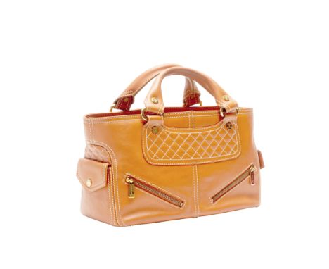 A CELINE BOOGIE TAN LEATHER HANDBAG
Tan with gold tone hardware and white stitching, with Celine dust bag and authenticity ca