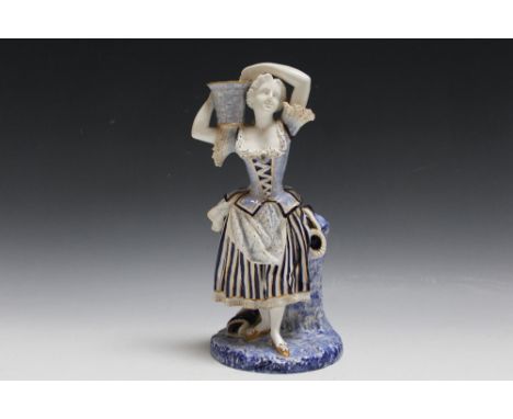 A ROYAL WORCESTER BLUE AND WHITE FIGURE OF A LADY CARRYING A BASKET, H 27 cm
