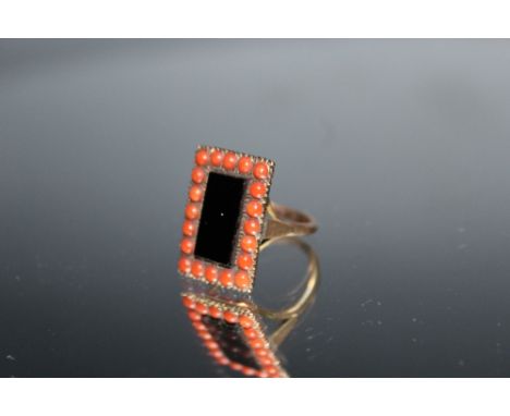 A VINTAGE DRESS RING, set with coral and polished stone, ring size M 1/2