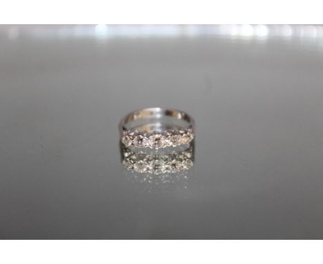 AN 18 CARAT WHITE GOLD FIVE STONE DIAMOND RING,  set with an estimated diamond weight of 0.56 carat, ring size P