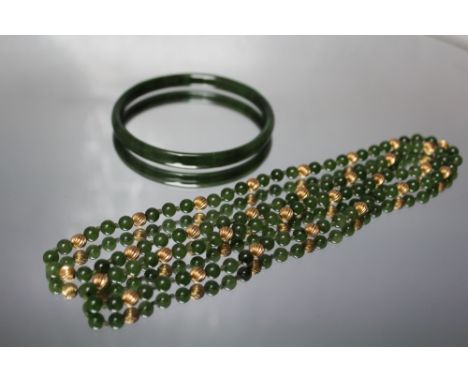 A SPINACH JADE AND YELLOW METAL HAND KNOTTED SINGLE STRAND BEAD NECKLACE, approx L 80 cm, together with a spinach jade bangle