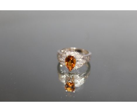 A 14K WHITE GOLD PEAR SHAPED CITRINE AND DIAMOND RING, the Citrine being an estimated 1.5 carat, ring size N