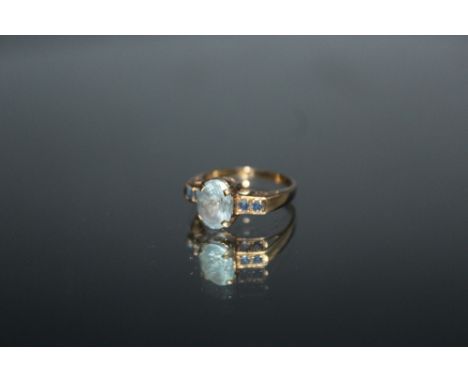 A HALLMARKED 9 CARAT GOLD DRESS RING, set with blue topaz and sapphire style stones, ring size N 1/2