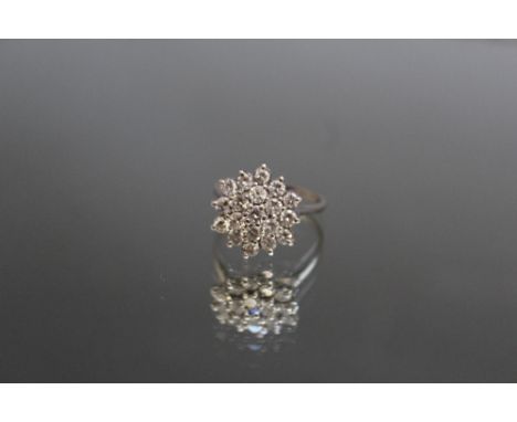 AN 18 CARAT WHITE GOLD DIAMOND CLUSTER RING, set with an estimated nineteen brilliant cut diamonds of an estimated 1 carat, r
