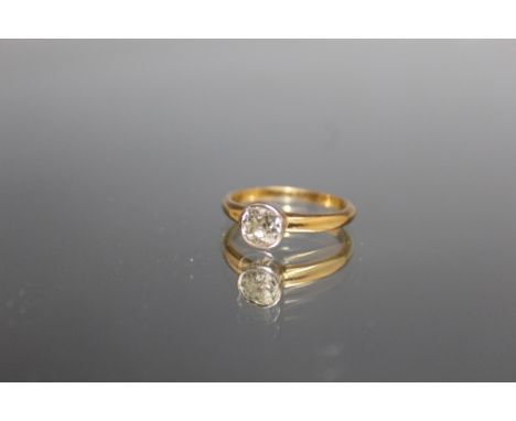 A DIAMOND SOLITAIRE RING, the brilliant cut diamond is rub over set and is of an estimated 1 carat, ring size O