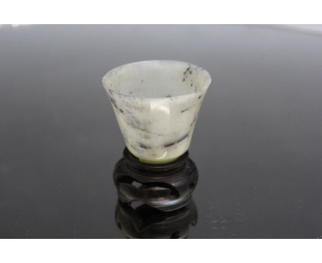 A SMALL JADE TYPE CUP, on matched stand, H 6.5 cm