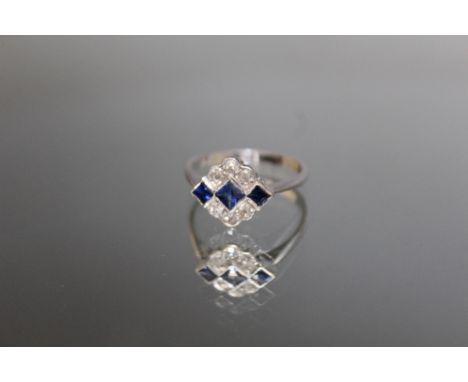 AN 18CT WHITE GOLD DECO STYLE SAPPHIRE AND DIAMOND RING, three sapphire being an estimated 0.33 carat and the six diamonds be