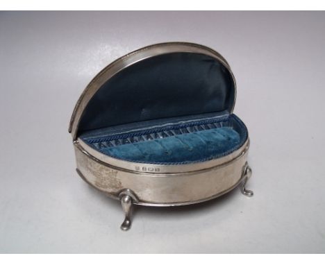 A HALLMARKED SILVER RING BOX - BIRMINGHAM 1923, of demi-lune form, raised on four outswept feet, the hinged lid opening to re