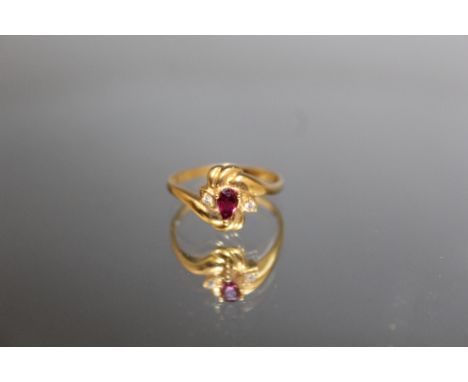 AN 18 CARAT YELLOW GOLD RUBY AND DIAMOND RING, the ruby being an estimated 0.30 carat, ring size O
