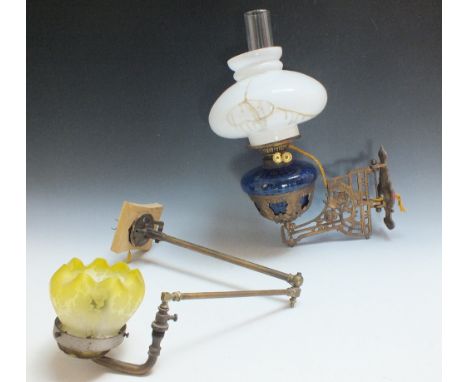 AN ANTIQUE WALL MOUNTED OIL LAMP, with blue glass reservoir, converted for electrical use, W 32 together with a 'pipework' ex
