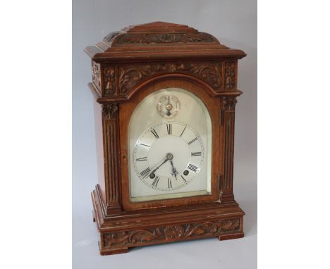 A WINTERHALDER &amp; HOFMEIER MAHOGANY CASED MANTLE CLOCK, the silvered arch top dial with subsidiary slow / fast dial above,