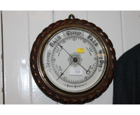 A CIRCULAR OAK FRAMED BAROMETER