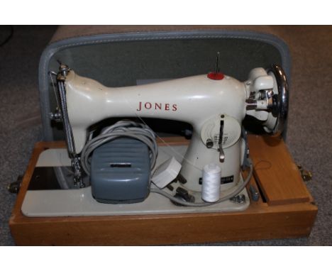 A VINTAGE CASED JONES SEWING MACHINE