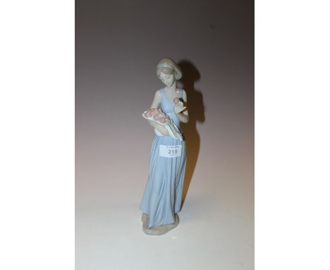 A NAO FIGURE OF A LADY HOLDING A BOUQUET OF FLOWERS