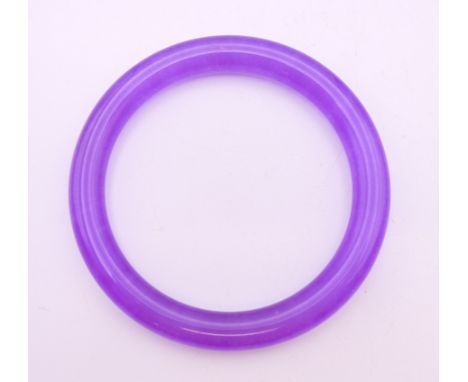 A lavender jade bangle.  5.75 cm internal diameter.