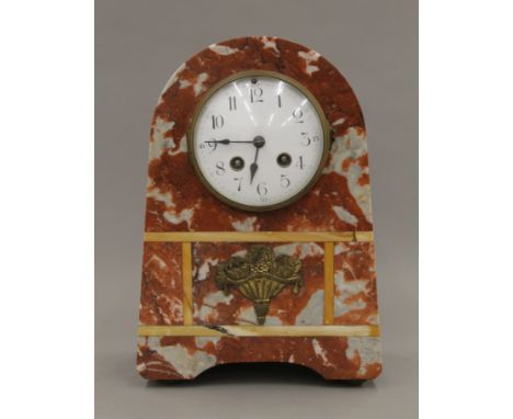 A French Art Deco marble mantle clock with brass appliques. 30 cm high.