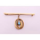 A 15 ct gold pin with plated turquoise set pendant. 5 cm long, pendant 2 cm high. 5.