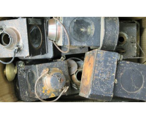 A quantity of vintage railway lanterns and ceramic wicks.