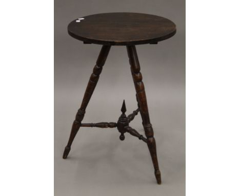 A 19th century mahogany gypsy table with turned bobbin legs and bobbin struts with central finial.  63.5 cm high, 45 cm diame