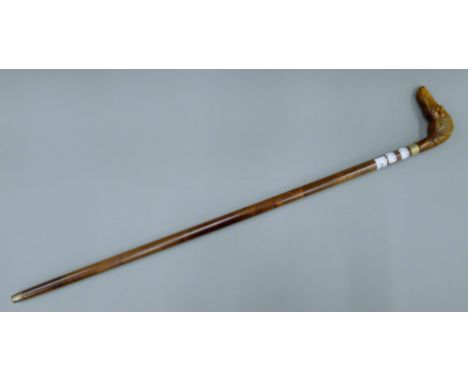 A walking stick, the handle formed as a dog's head. 93 cm long.