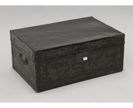 A 19th century Chinese black leather trunk with flower decoration and brass fittings. 58 cm wide.